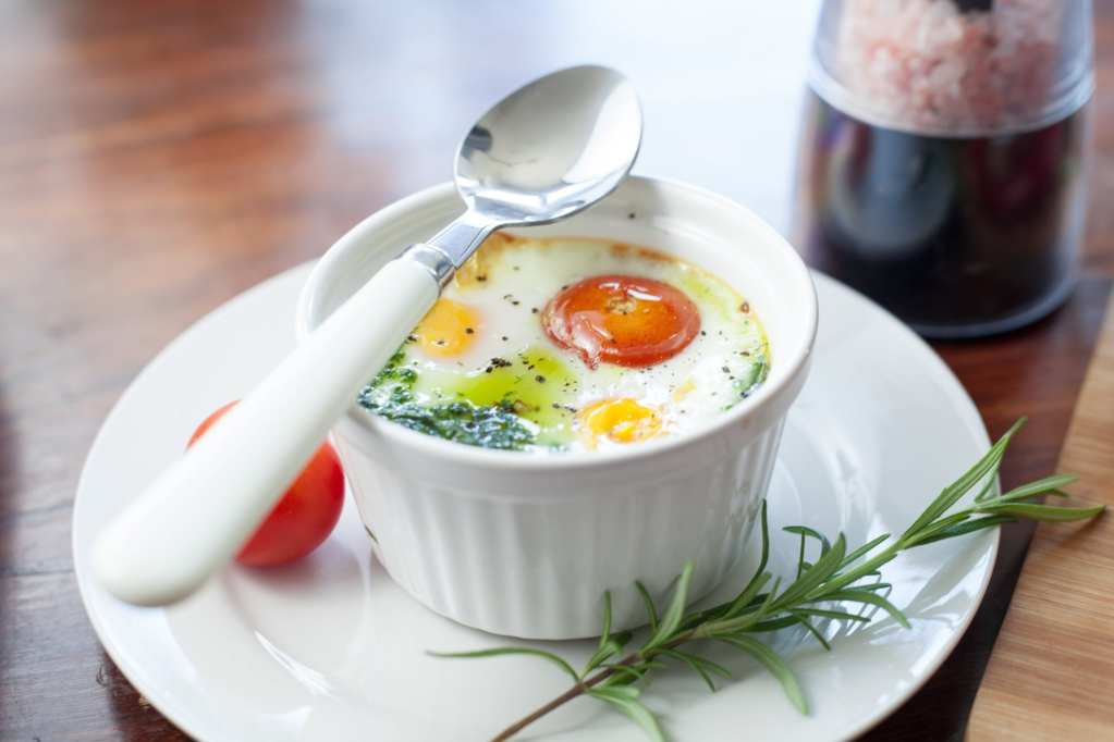 Baked Eggs with Harissa Cream and Roasted Diced Tomatoes